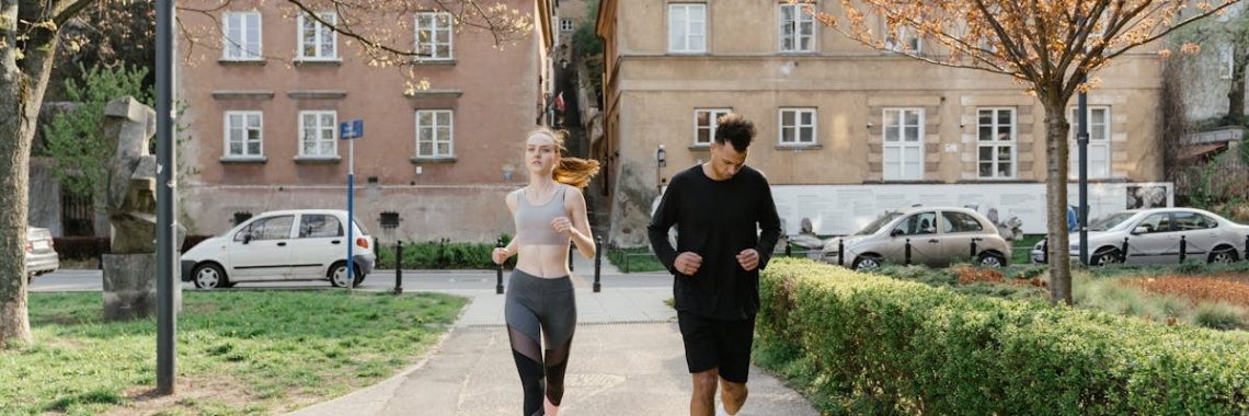 A couple jogging together in an urban park, enjoying outdoor exercise.